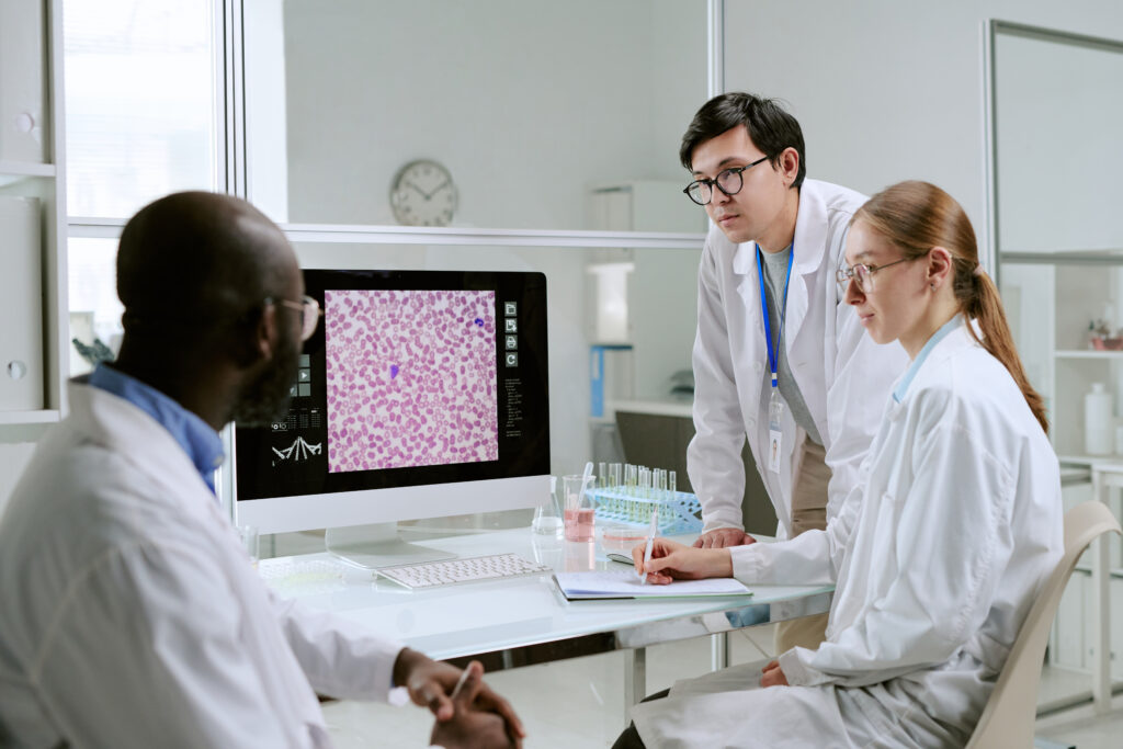 Pathologists review a digital slide on a computer